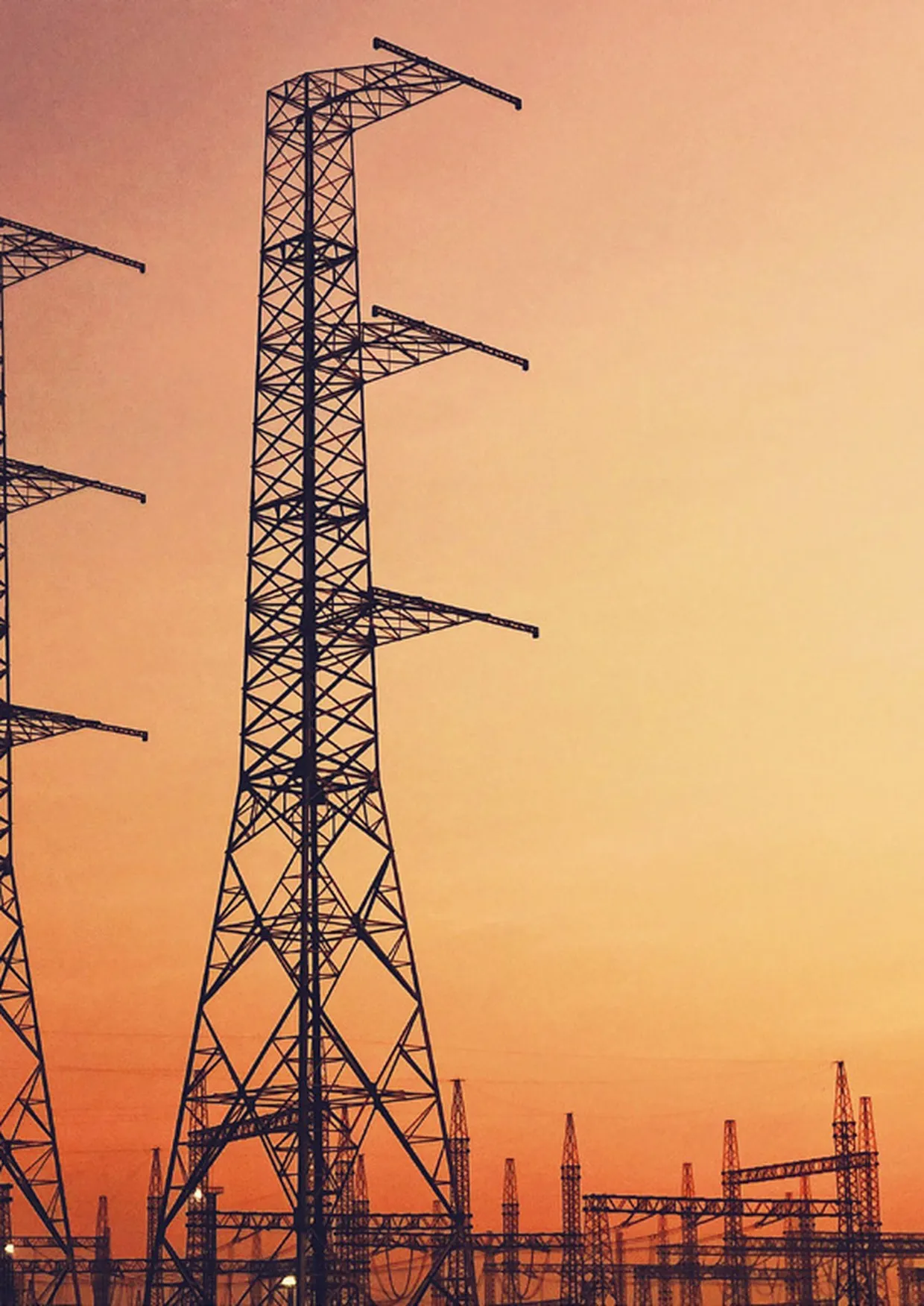 High-voltage power transmission infrastructure at dusk.
